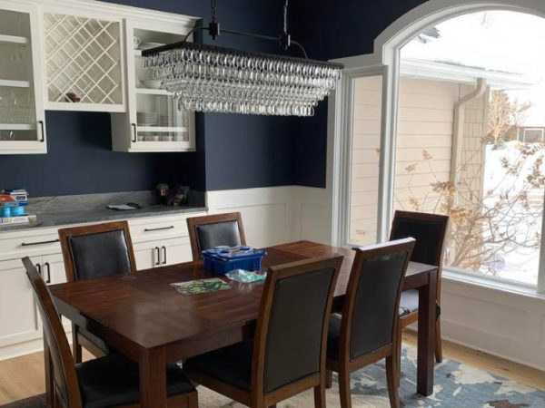 dining room area with blue and white walls and dining room set after interior painting